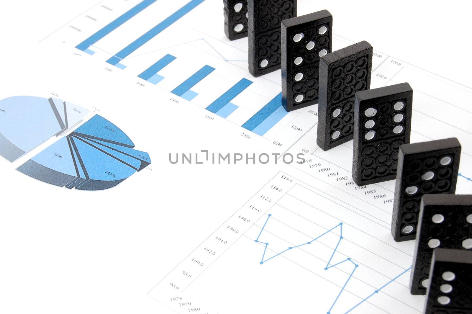 some domino stones on a blue business chart