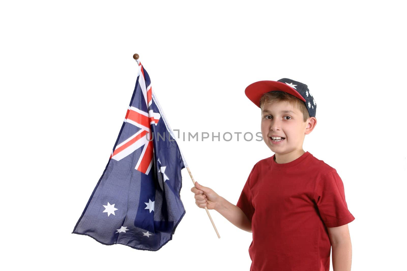 Young boy holding an Australian flag in his hand.