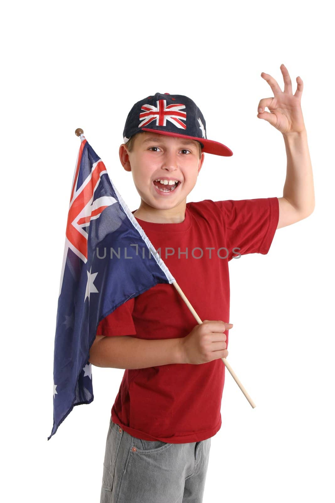 A young proud Australian (Aussie)  boy carrying a flag makes an A1 gesture.