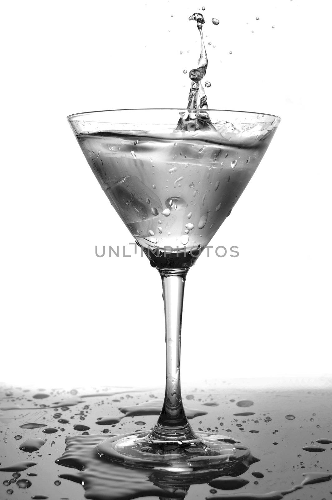 glass of cool splashing water isolated on white background