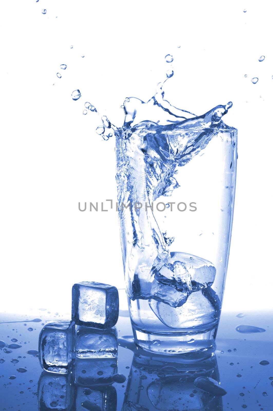 pouring fresh water in a glass on white