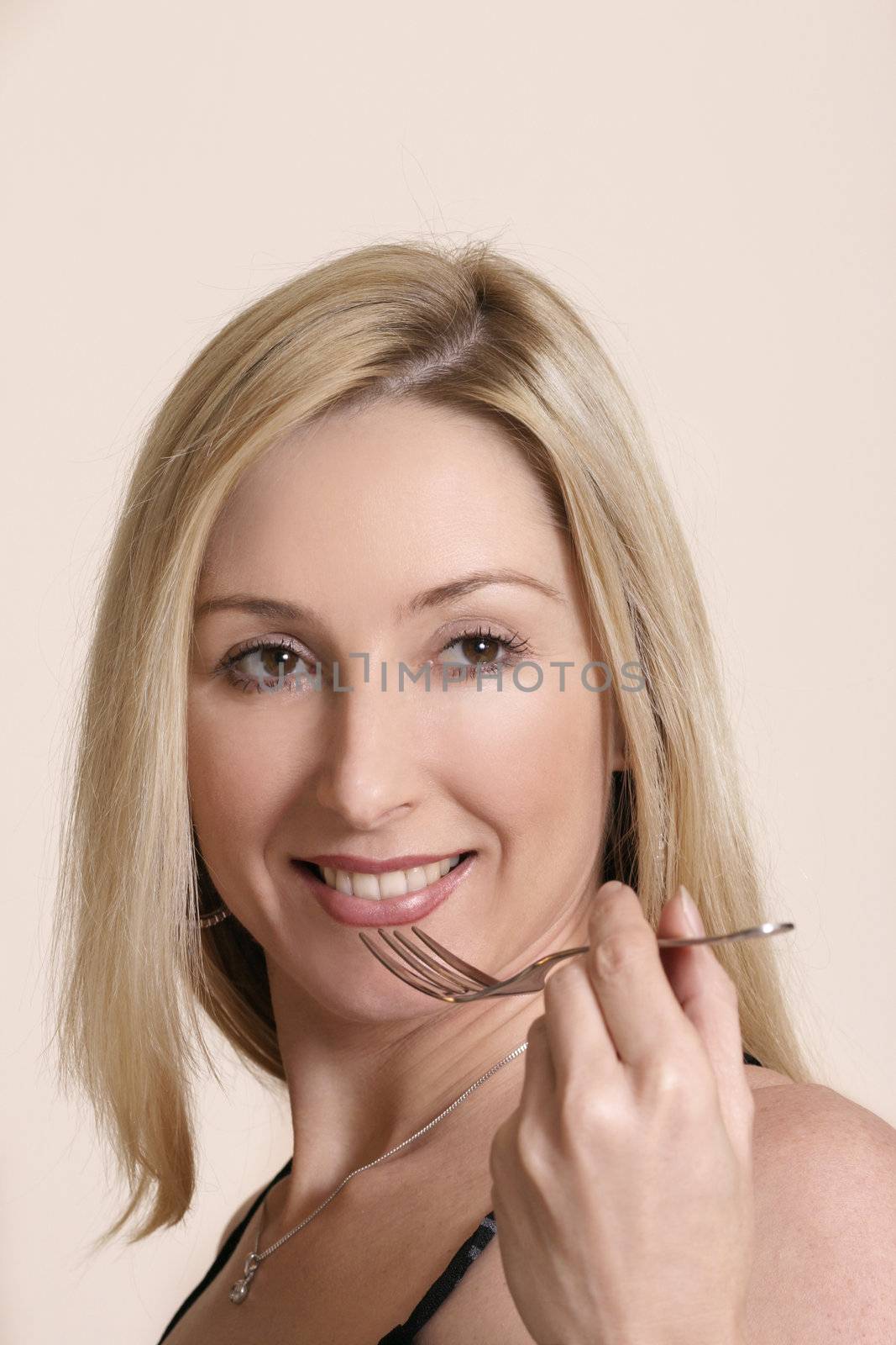 Smiling woman holding cutlery