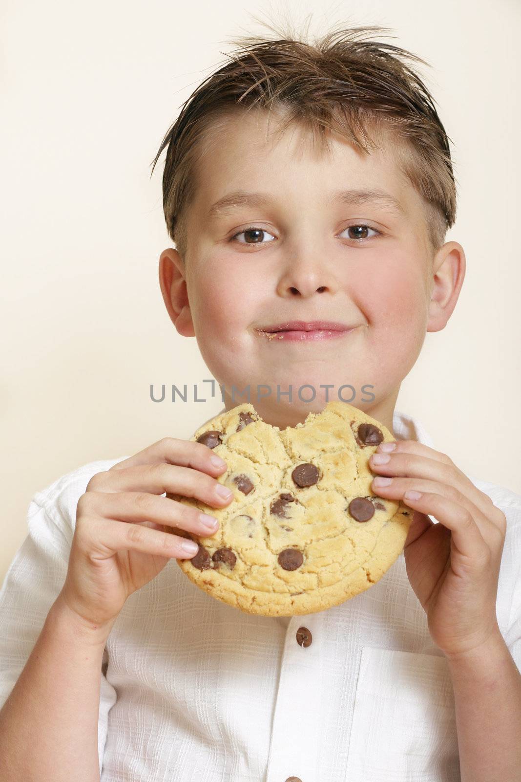 Boy with large cookie and smiling