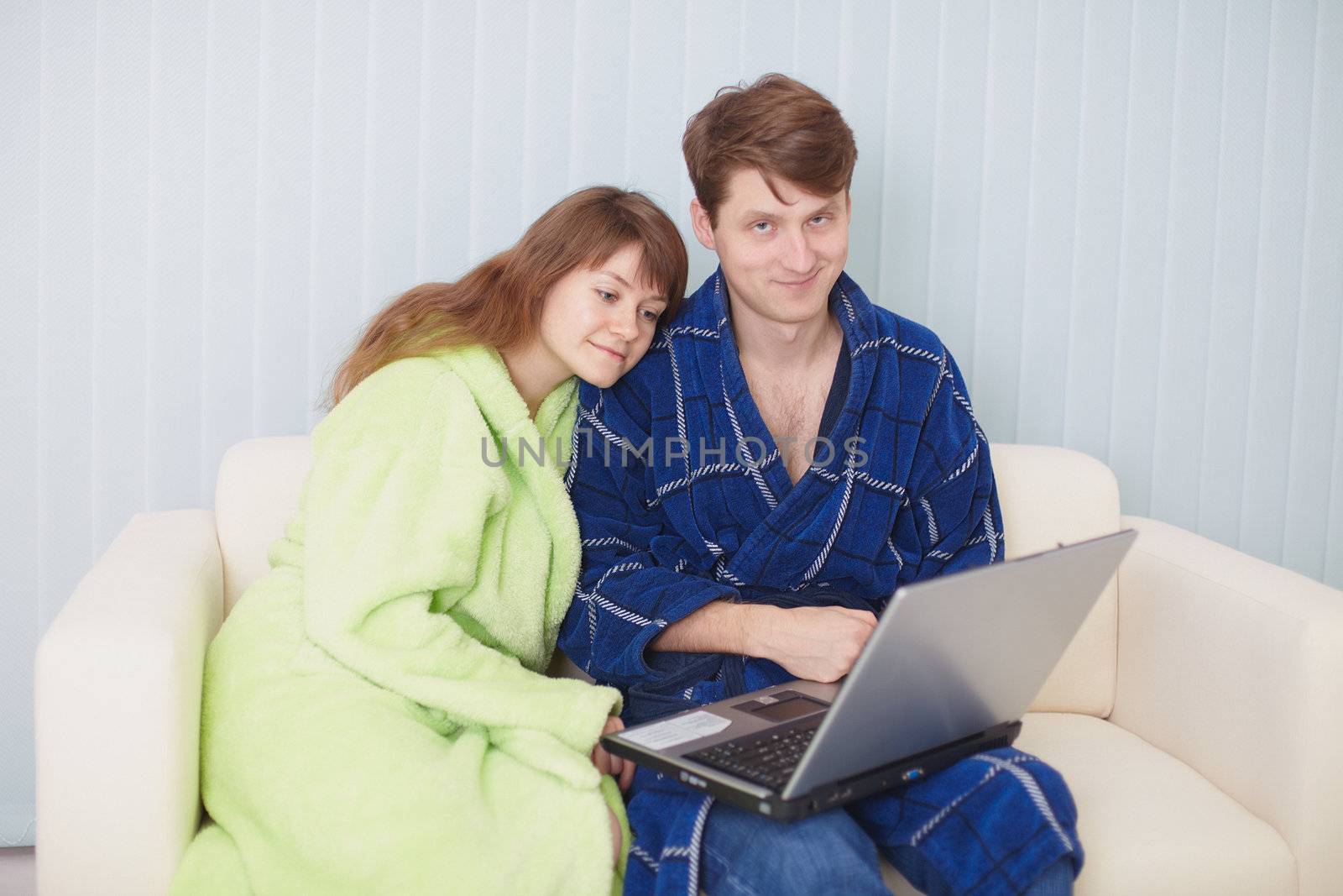 Young couple on a couch with the laptop