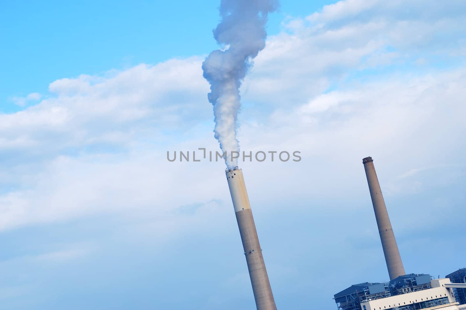 Smokestacks of power station on sky background