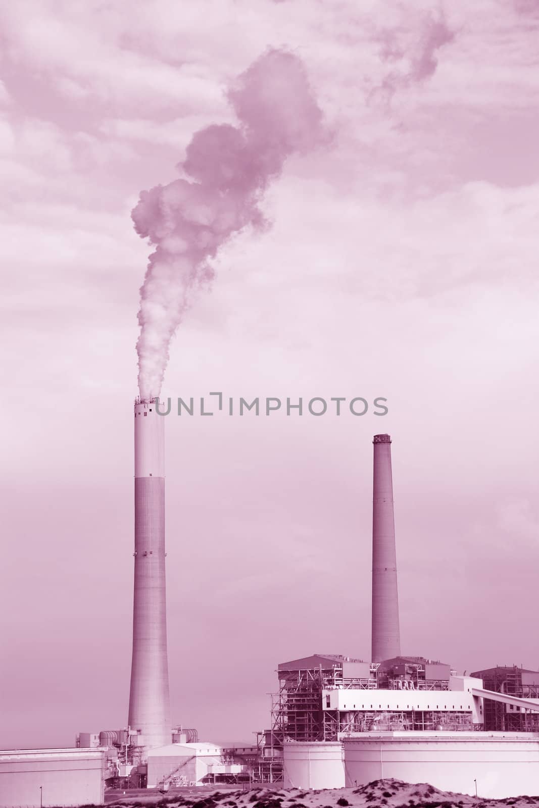 Smokestacks of power station on sky background