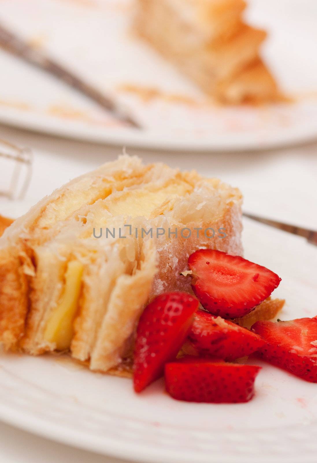 Portion of homemade cake, pastry cream and strawberries