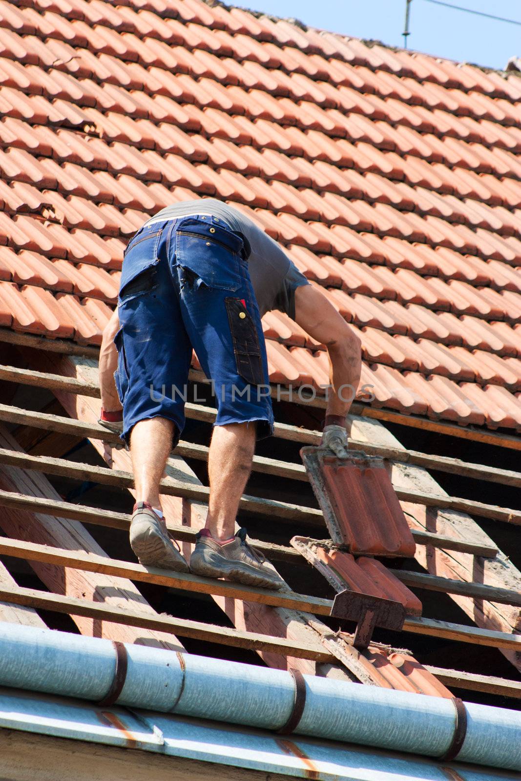 Man working in the roof of a building