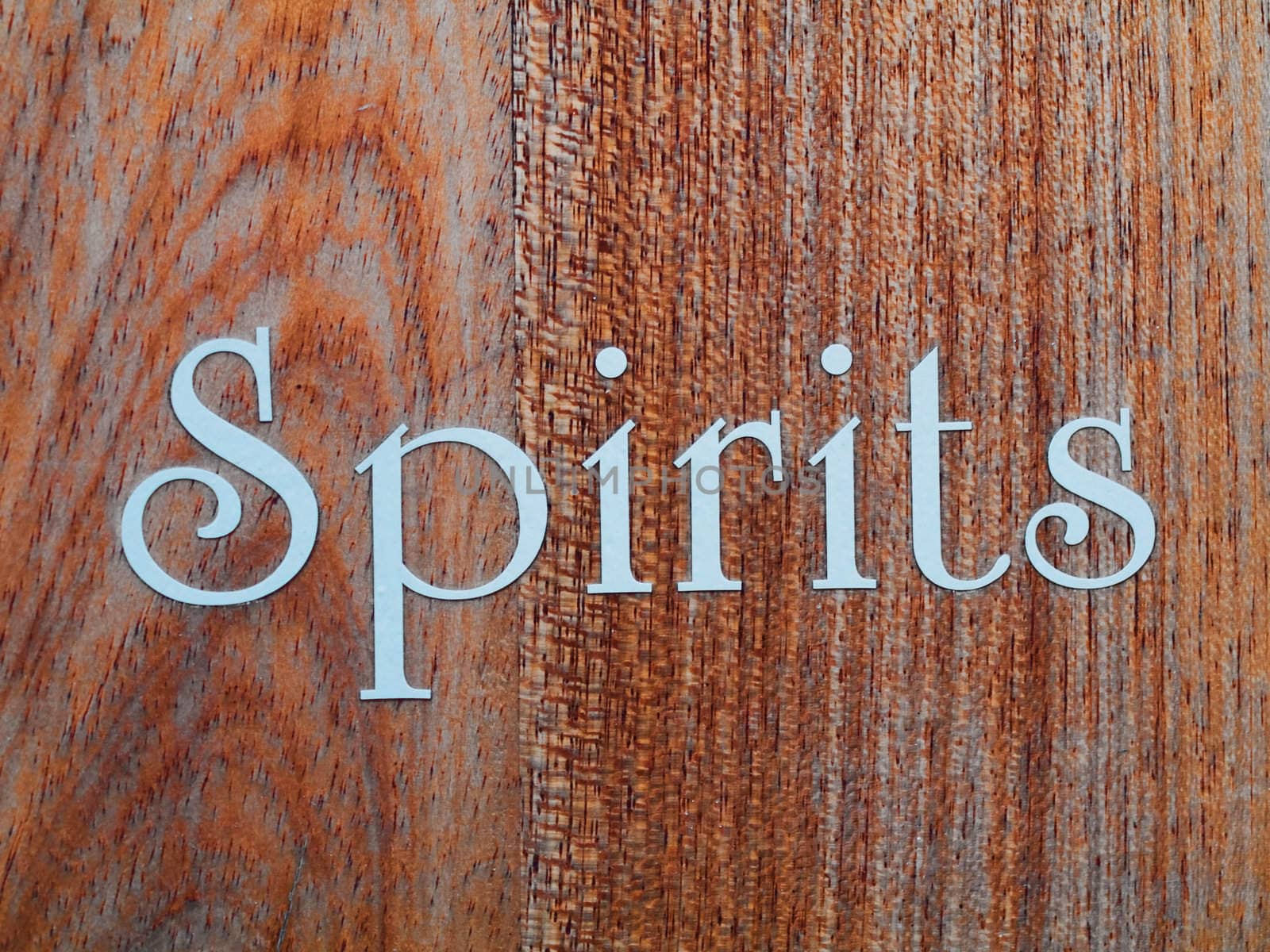 Spirits  in white letter written on wood panel 