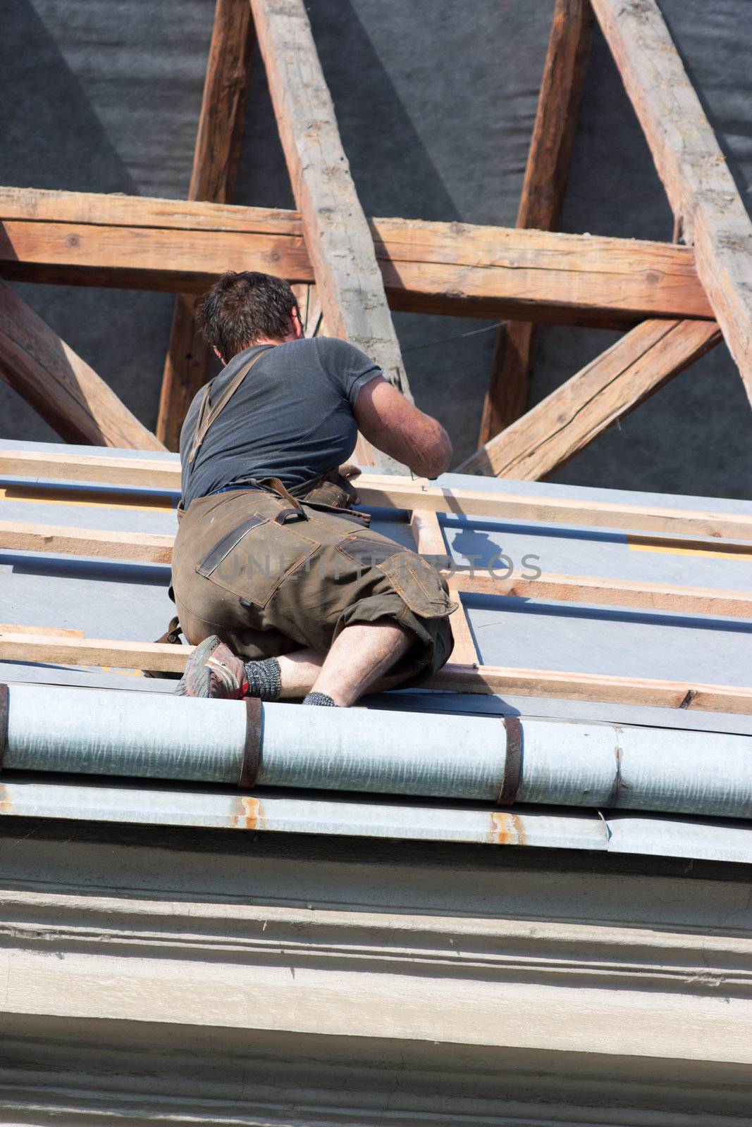 Man working in the roof of a building