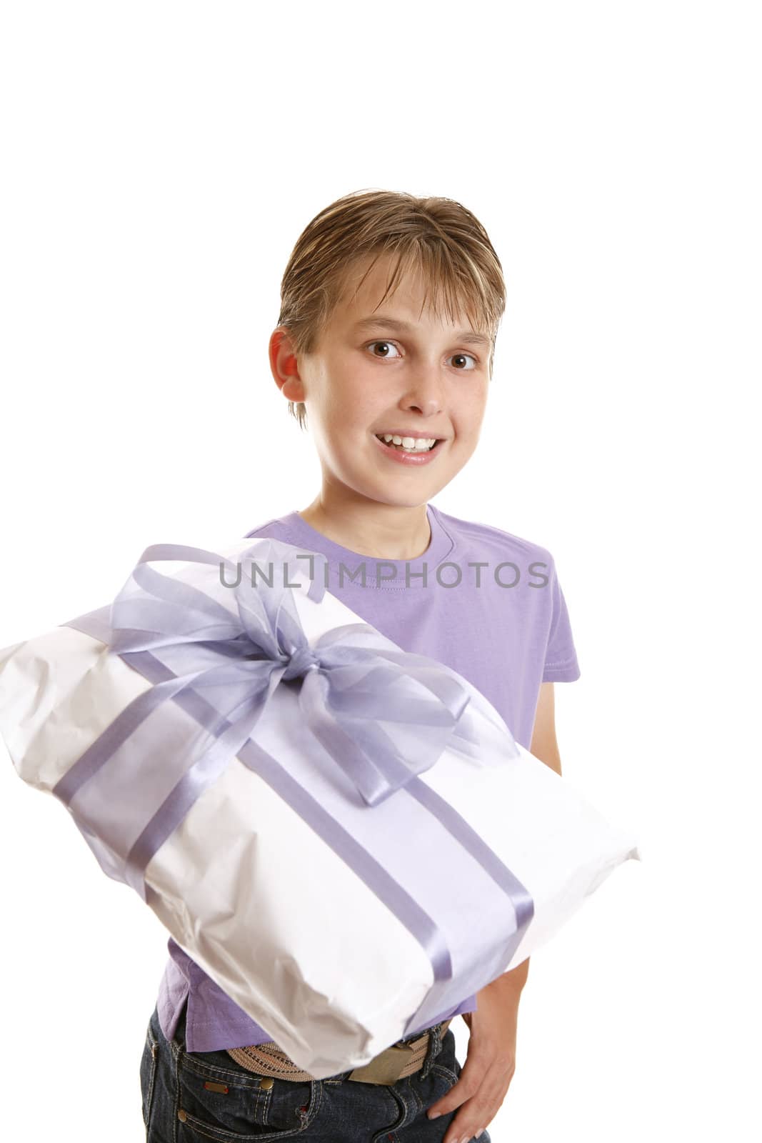 A boy holds a wrapped present tied up with gauze and satin purple ribbon.