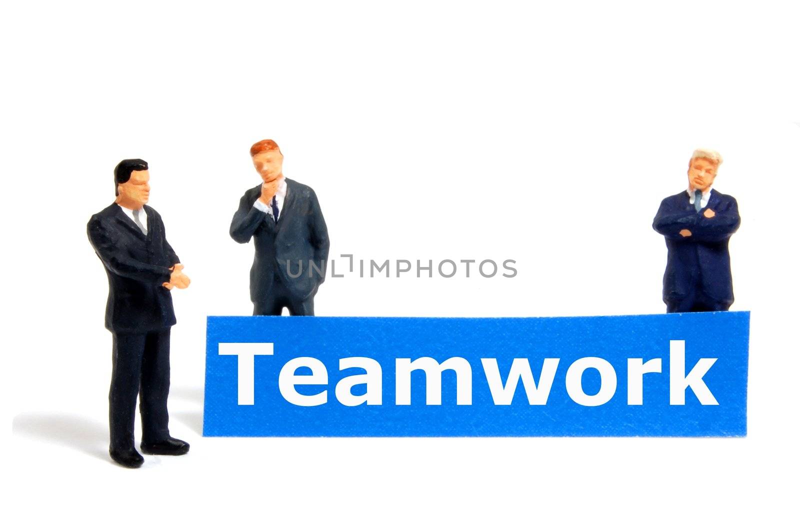 team or teamwork business concept with tiny toy business man isolated on white background