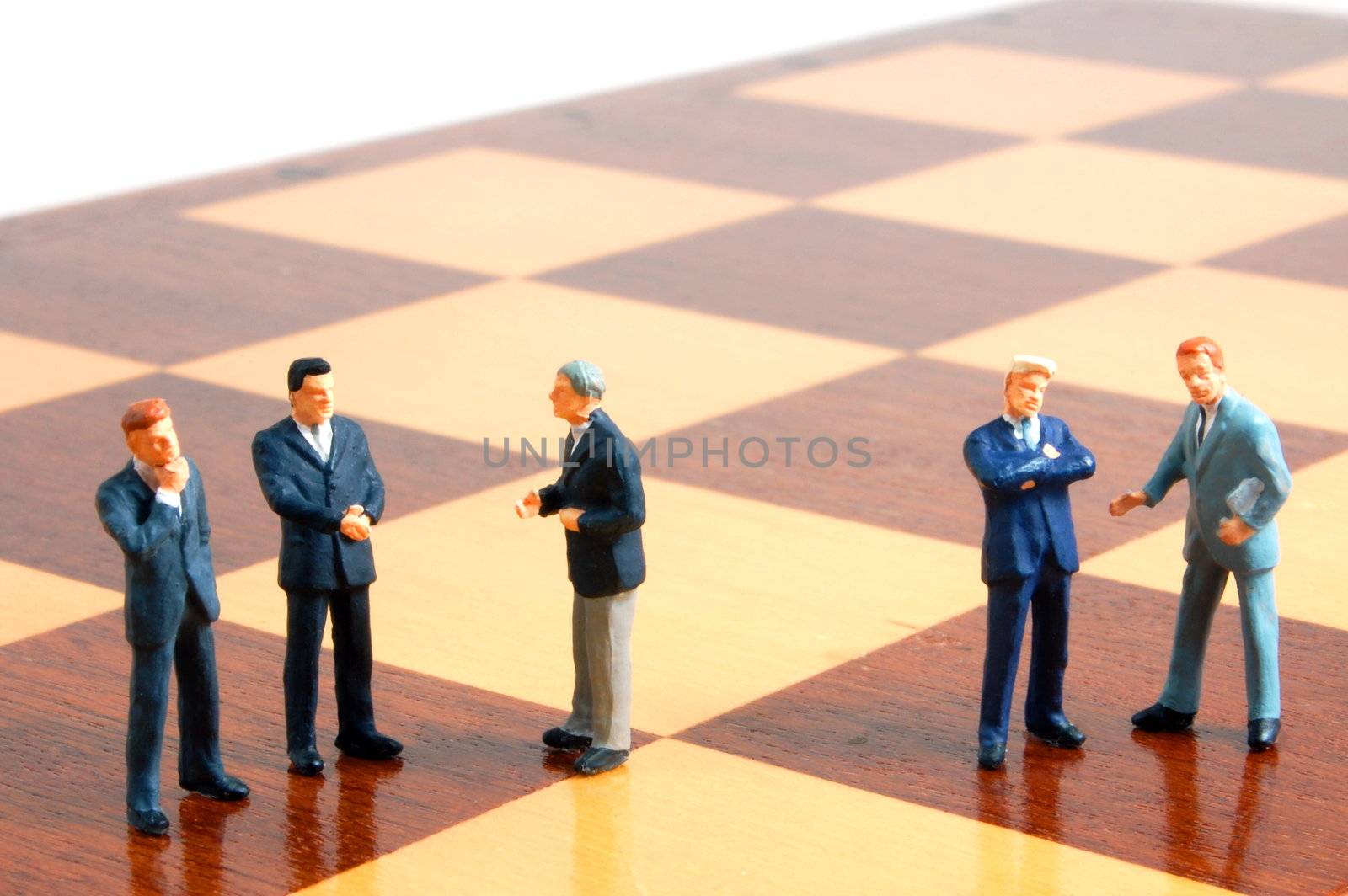 group uf business people standing on a chess board