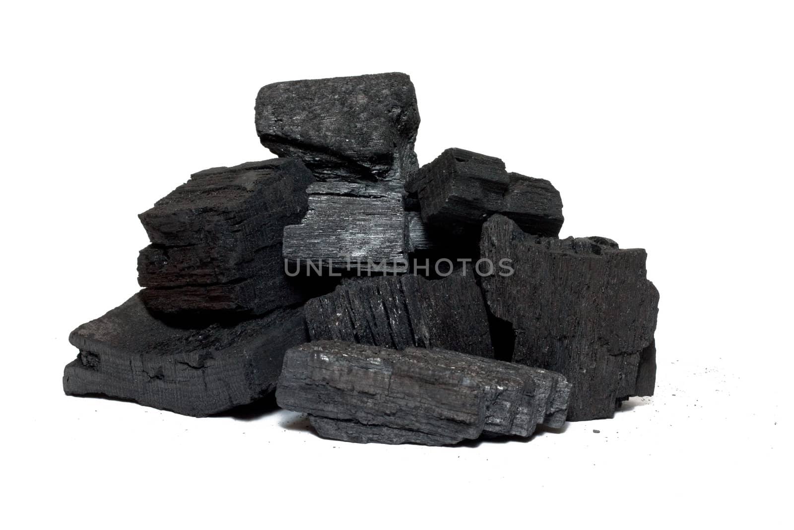 Bits of charcoal prepared to burn isolated on white 