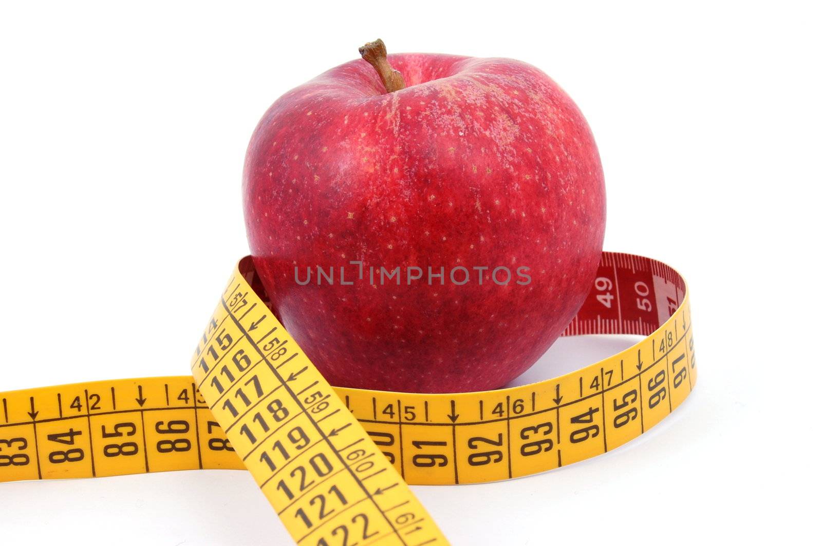 Apple and measuring tape on white by gunnar3000