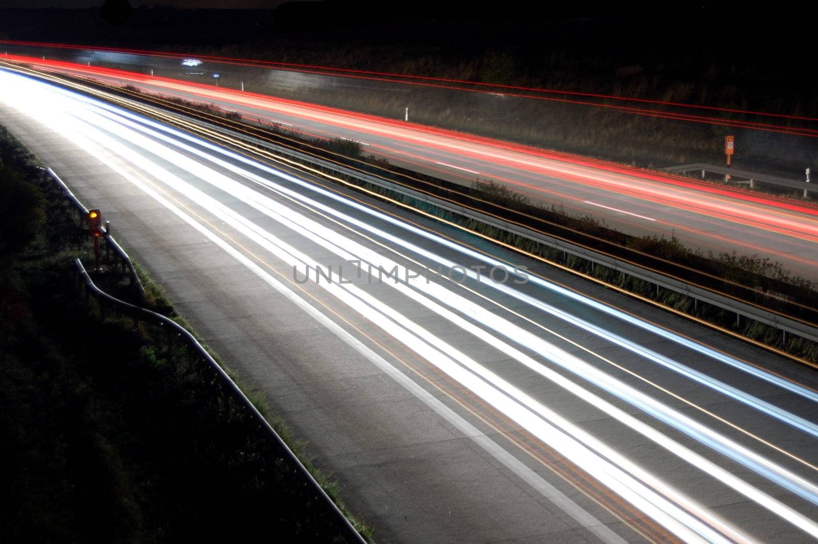 highway at night with car traffic and lights