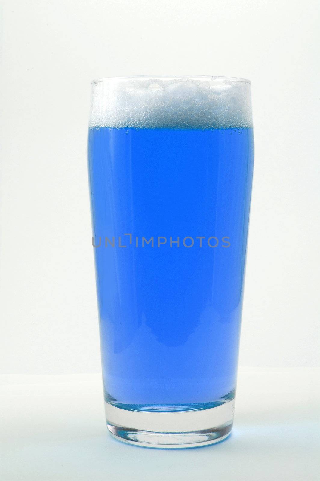 colored drink with foam isolated on white background