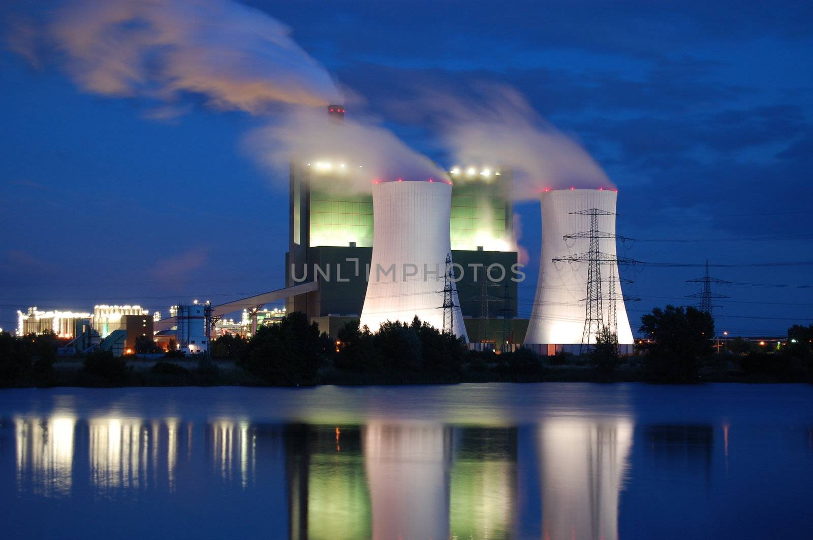 a smoking industrial power plant at night