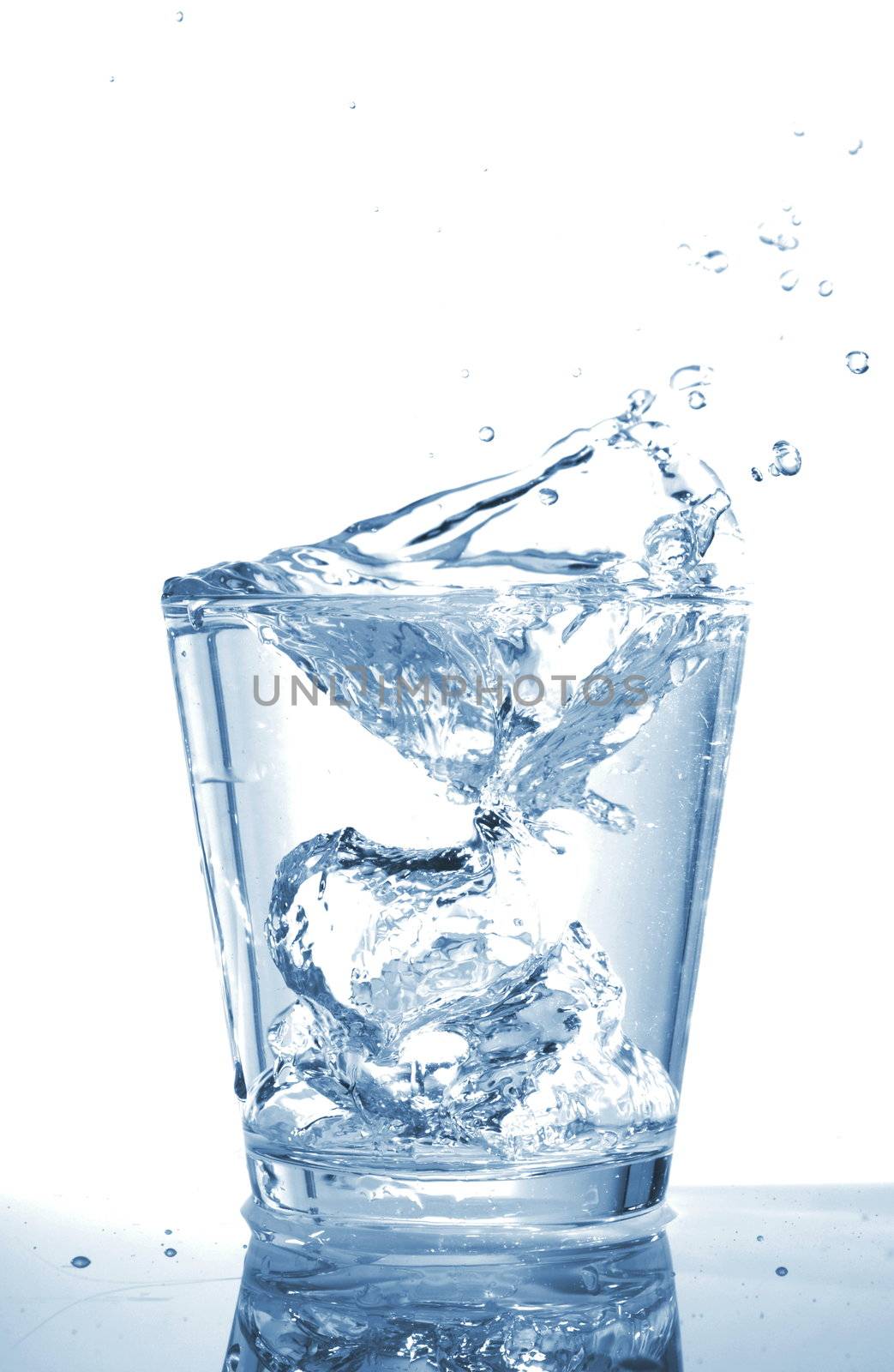glass of ice water with bubbles on white background