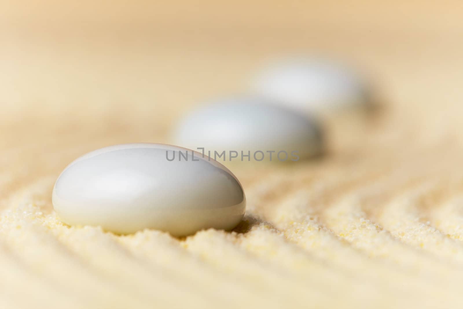 Abstract composition - glass drops on sand surface