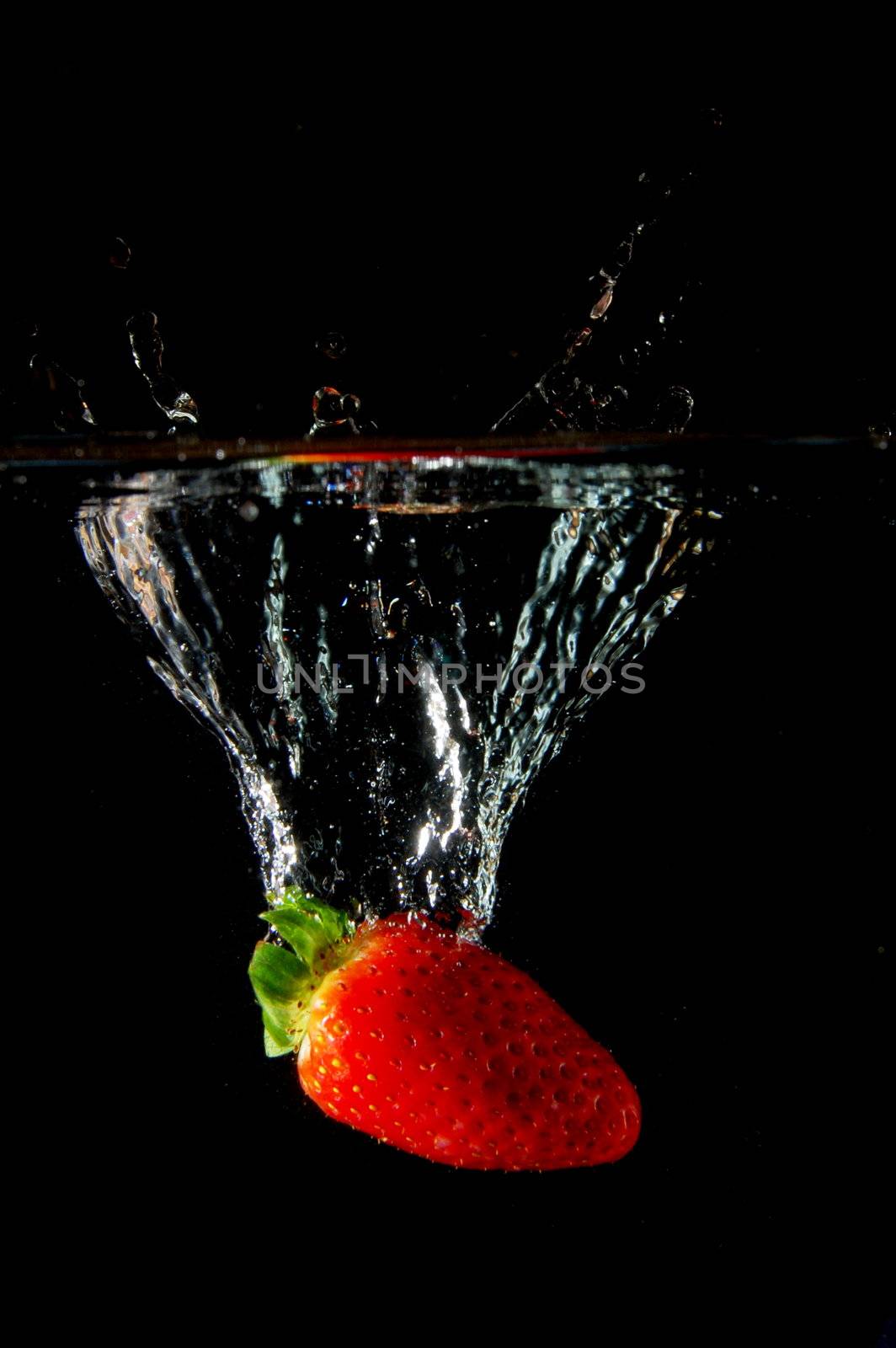 strawberrys splashing in fresh water showing healthy lifestyle
