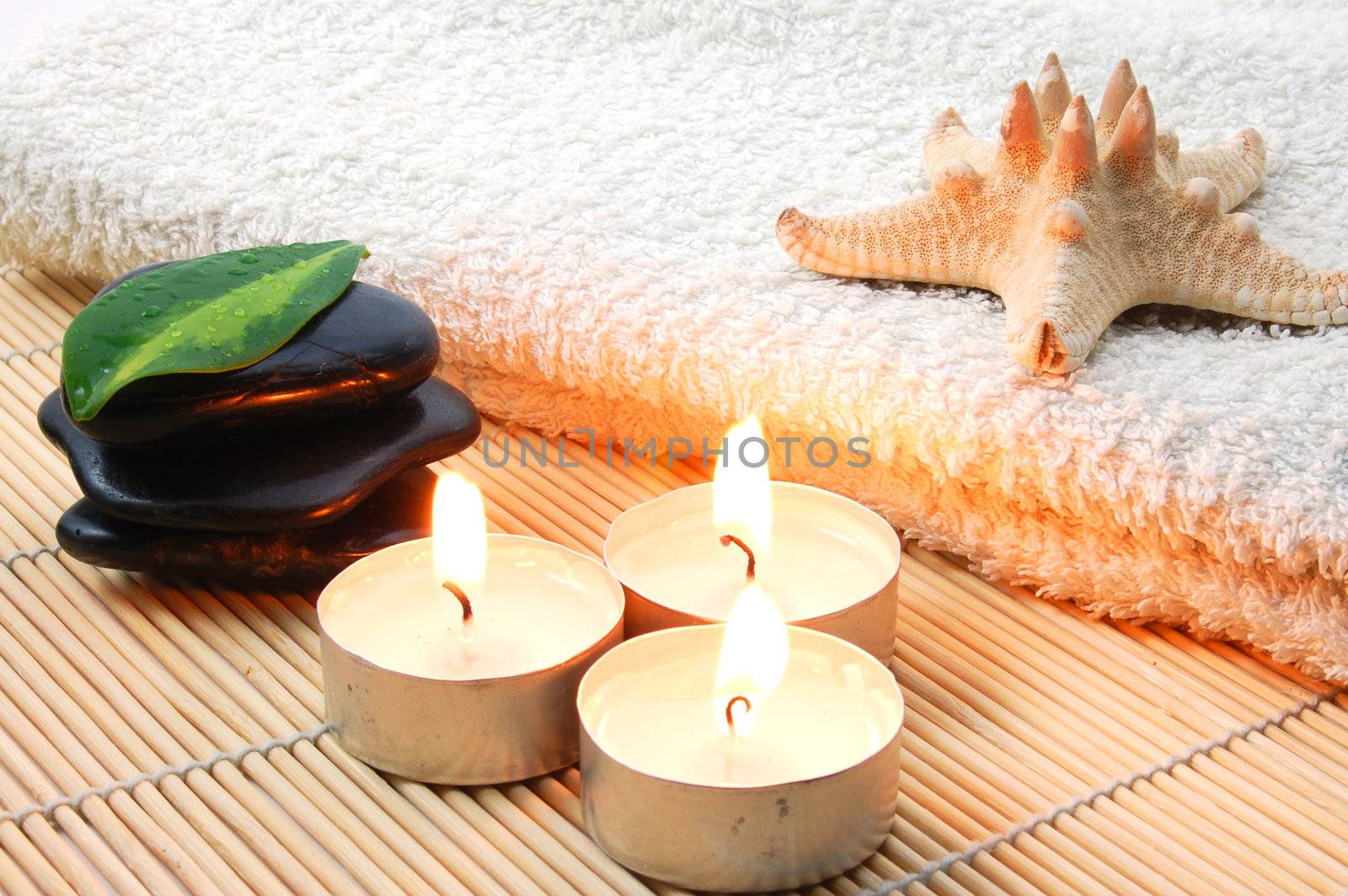 towel and zen stones showing a bath or wellness concept