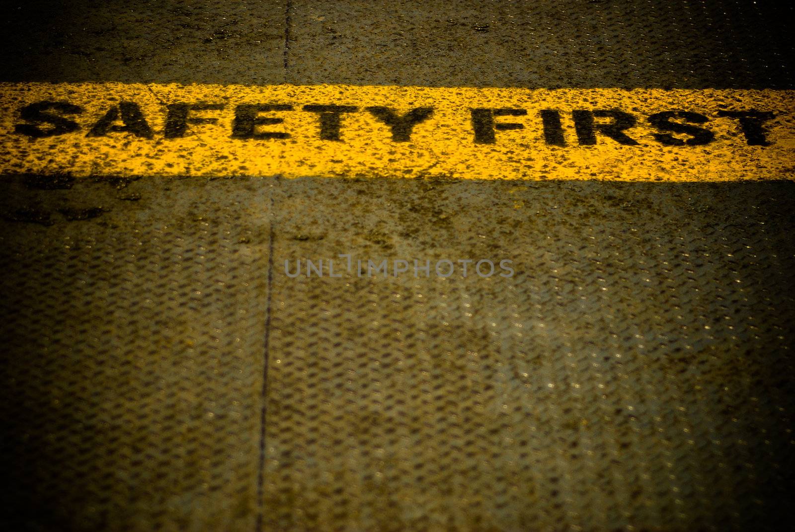 Safety first sign words on the metal ground