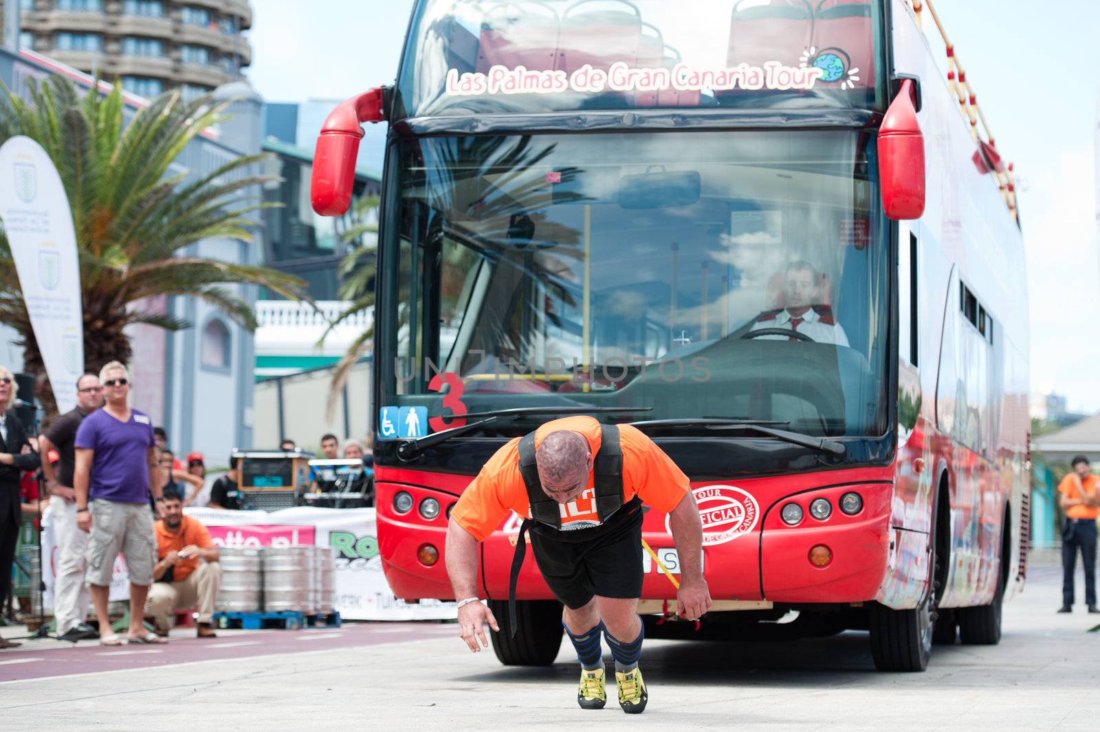 CANARY ISLANDS – SEPTEMBER 03: Ervin Katona from Serbia pulling a double-decker bus behind himself during Strongman Champions League in Las Palmas September 03, 2011 in Canary Islands, Spain