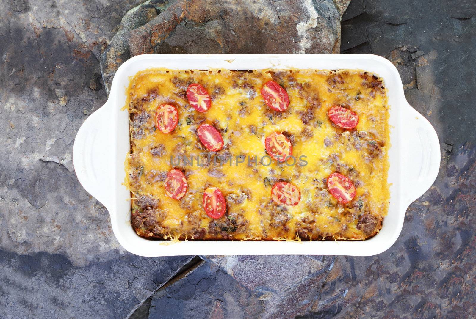 Hash Brown Strata or Breakfast Casserole made with a crust of hash browns, eggs, sausage and cheddar cheese.
