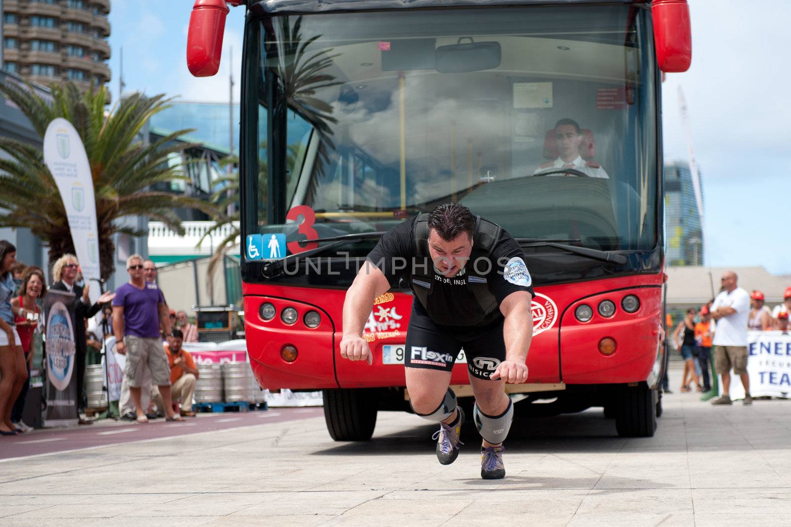 CANARY ISLANDS – SEPTEMBER 03: Arno Hams from Holland pulling a double-decker bus behind himself during Strongman Champions League in Las Palmas September 03, 2011 in Canary Islands, Spain