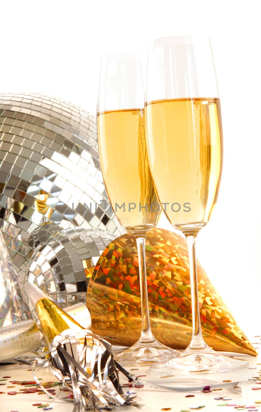 Champagne glass with gold party hats and disco ball