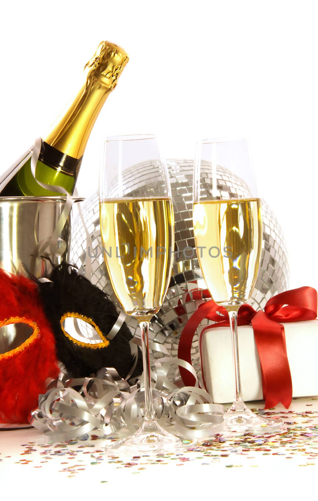 Glasses of champagne with mask and party hats  on white