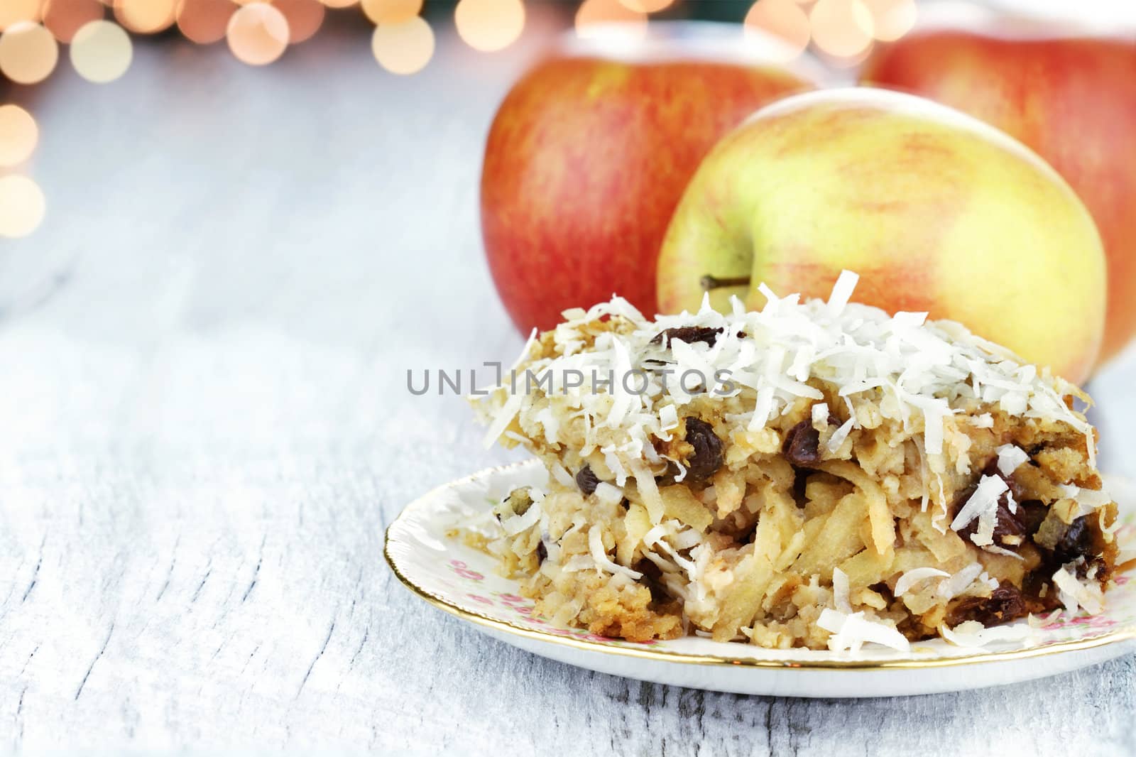 Apple casserole made of shredded apples, oats, coconut and raisins. Shallow depth of field with room for copy space. 