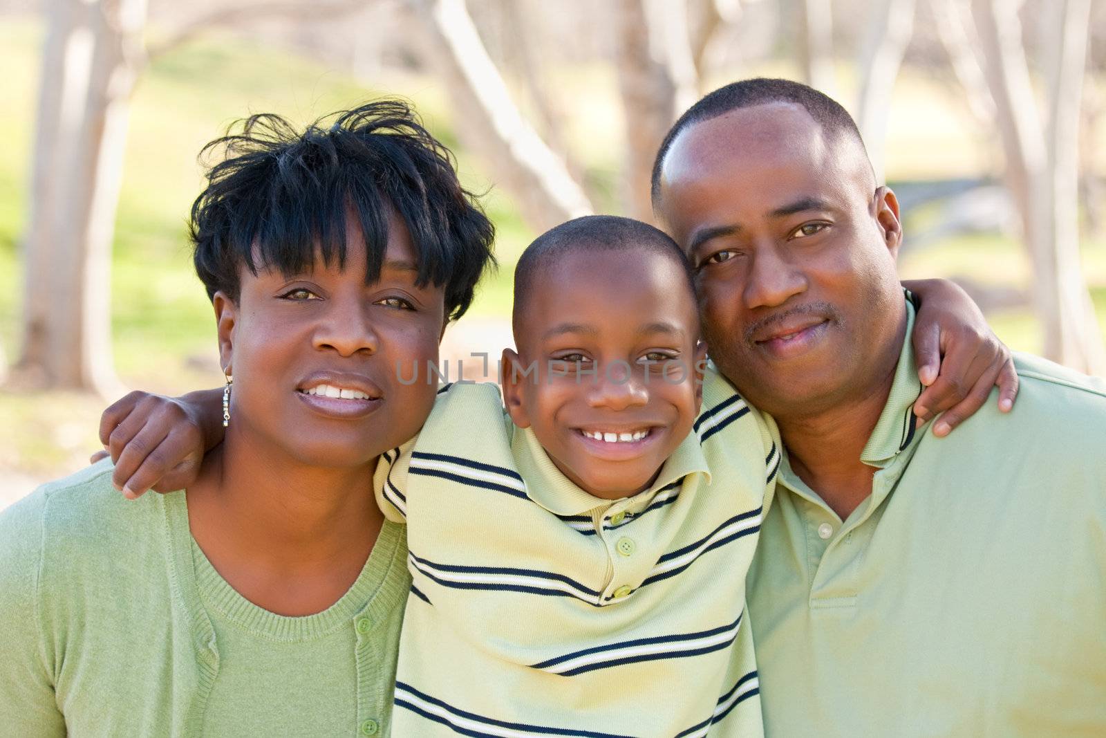 Happy African American Man, Woman and Child Having Fun in the Park.