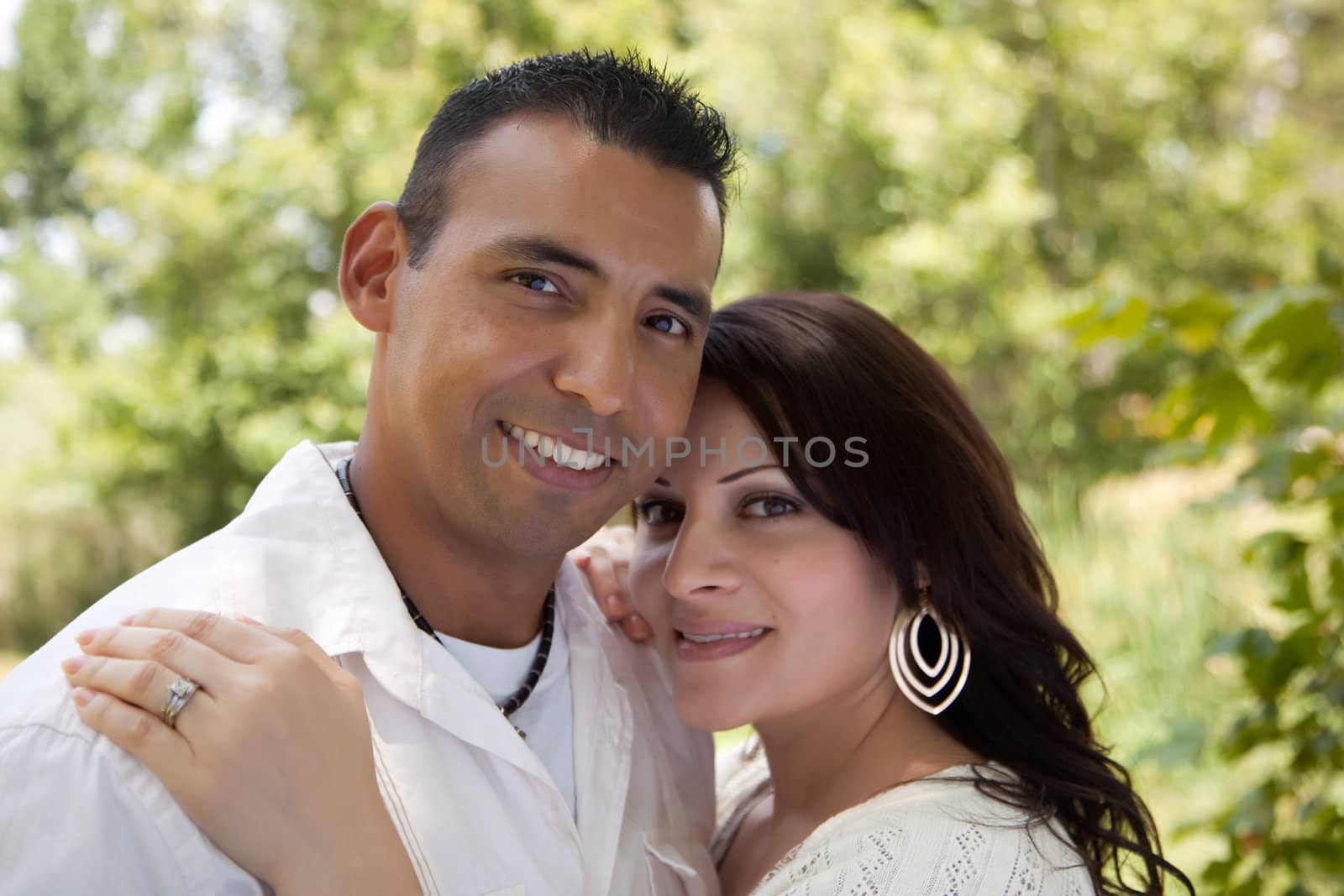 Attractive Hispanic Couple Portrait in the Park.