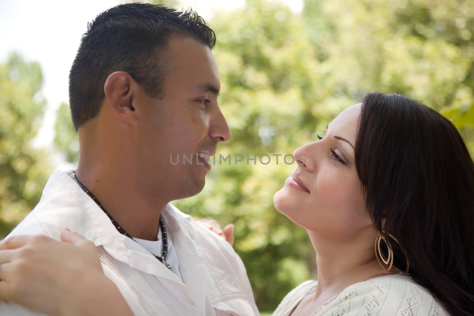 Attractive Hispanic Couple Portrait in the Park.