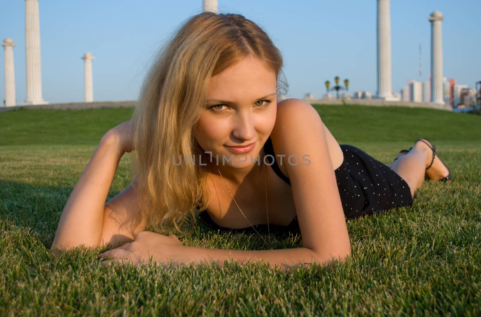 Young pretty woman lying on grass 