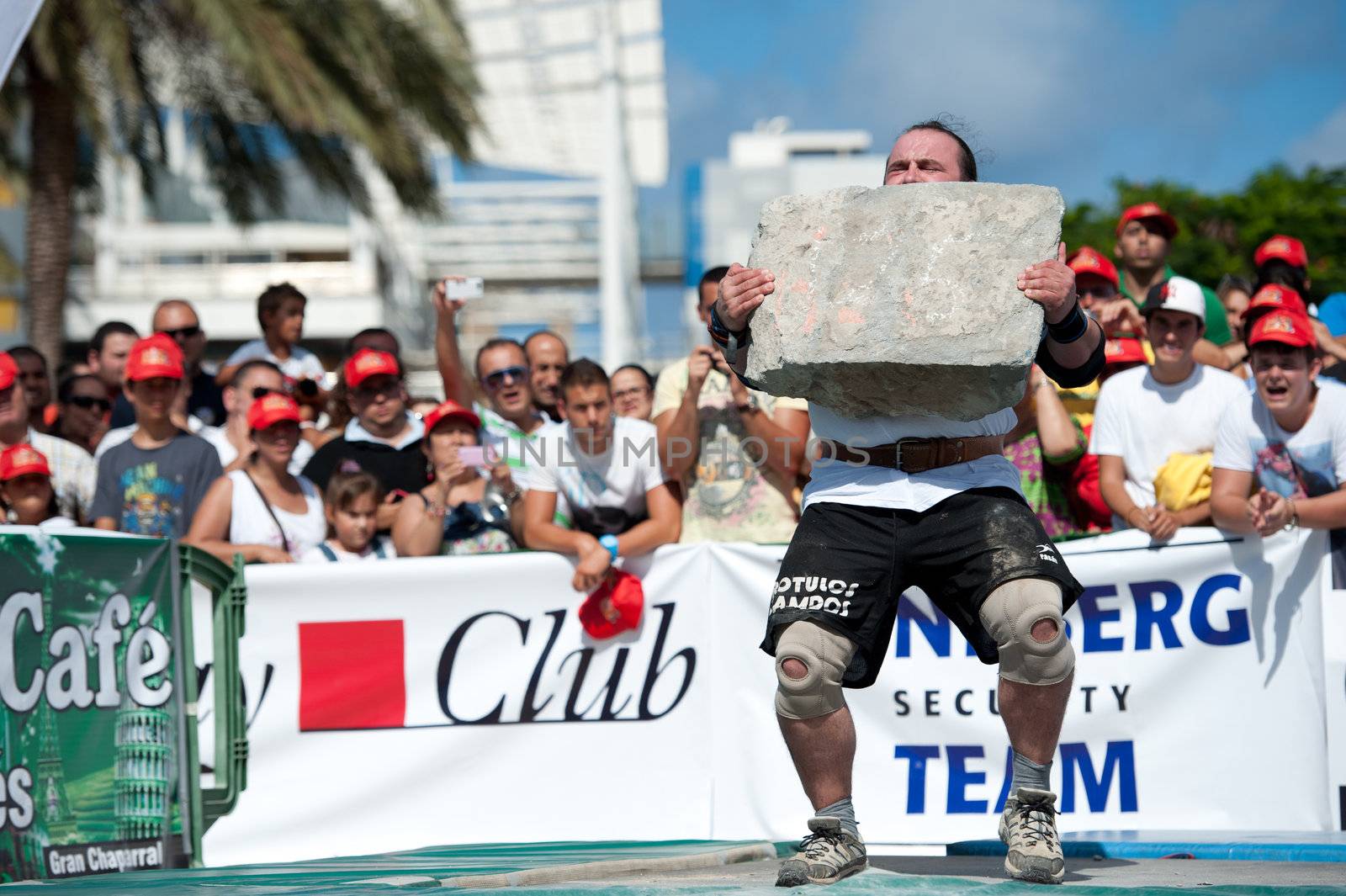 CANARY ISLANDS – SEPTEMBER 03: Julio Jimenez Zancajo from Spain lifting a heavy stone during Strongman Champions League in Las Palmas September 03, 2011 in Canary Islands, Spain