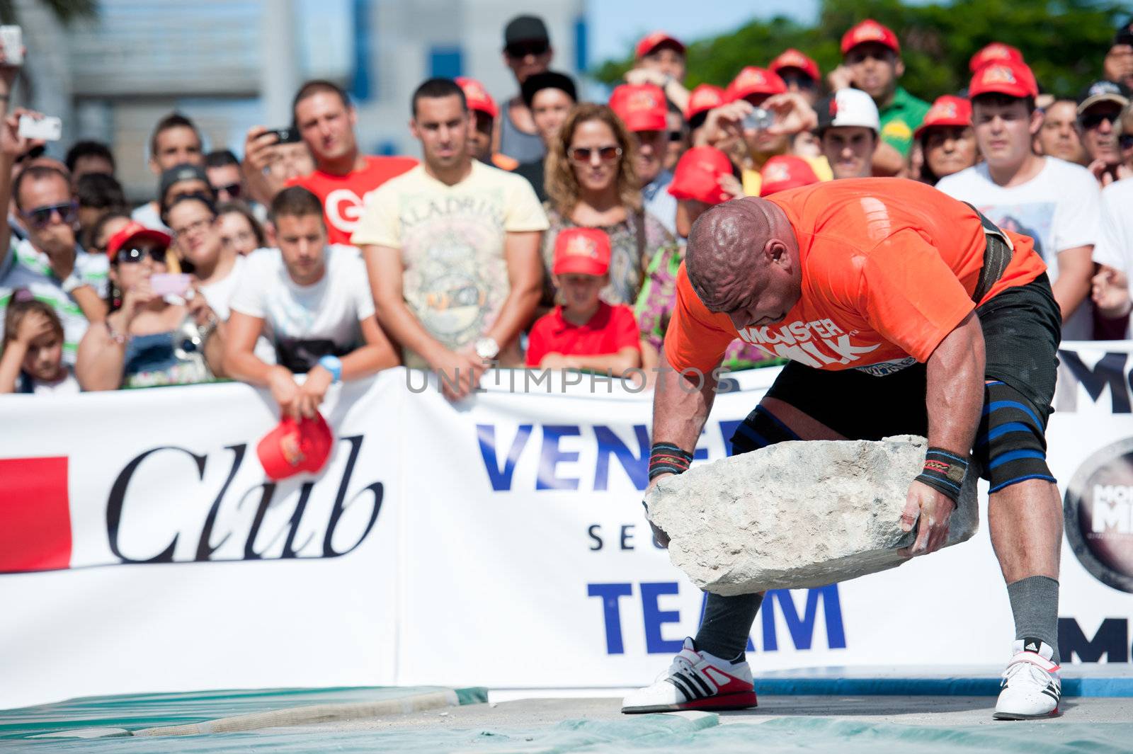 CANARY ISLANDS – SEPTEMBER 03: Ervin Katona from Serbia lifting a heavy stone during Strongman Champions League in Las Palmas September 03, 2011 in Canary Islands, Spain