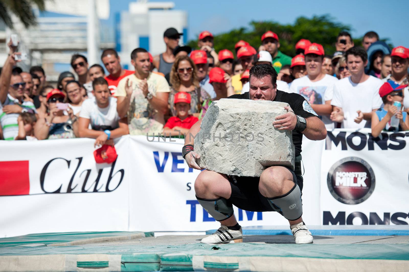 CANARY ISLANDS – SEPTEMBER 03: Alex Curletto from Italy lifting a heavy stone during Strongman Champions League in Las Palmas September 03, 2011 in Canary Islands, Spain