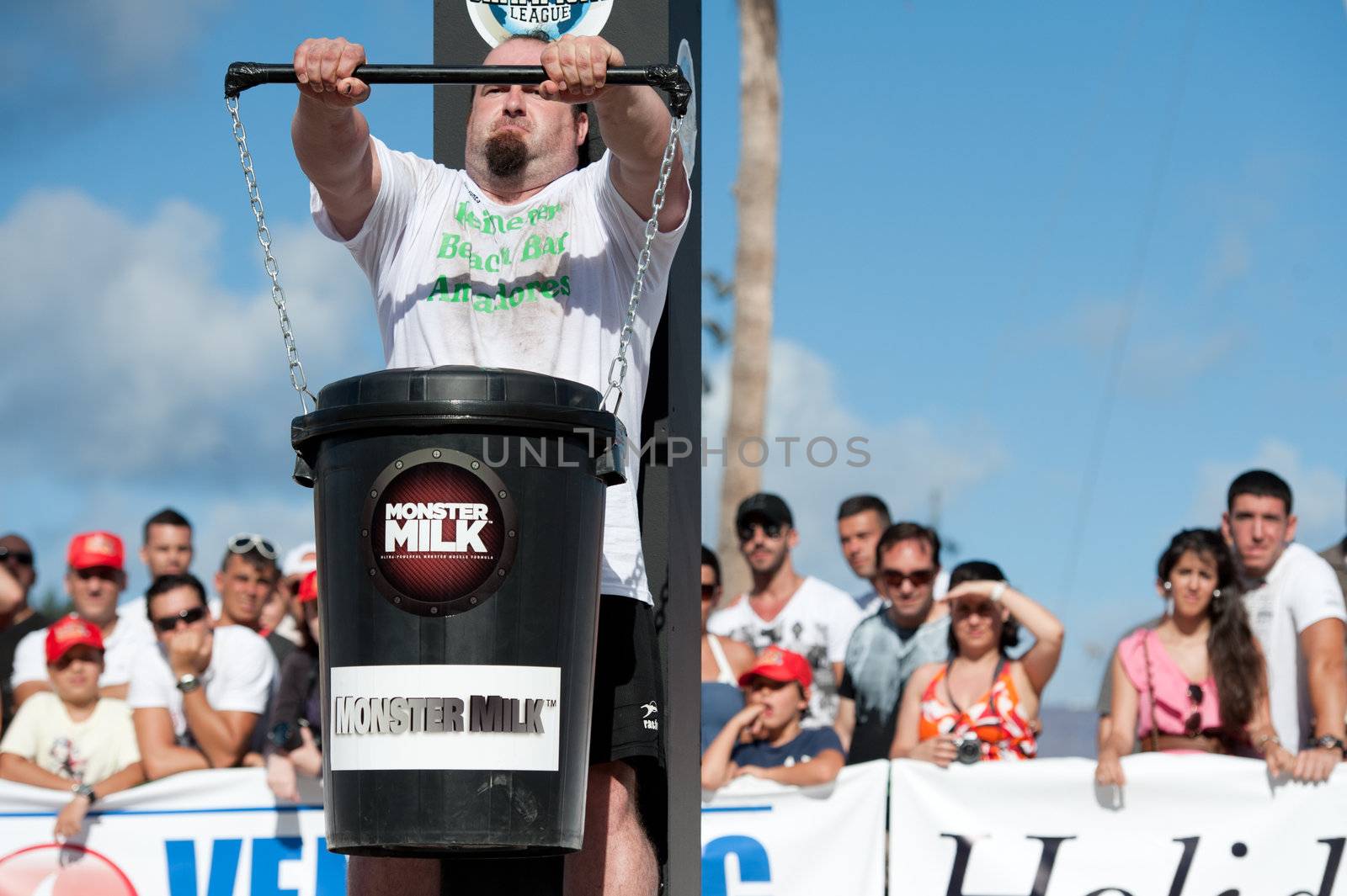 CANARY ISLANDS - SEPTEMBER 03: Julio Jimenez Zancajo from Spain lifting a heavy trash can for longest possible time during Strongman Champions League in Las Palmas September 03, 2011 in Canary Islands, Spain