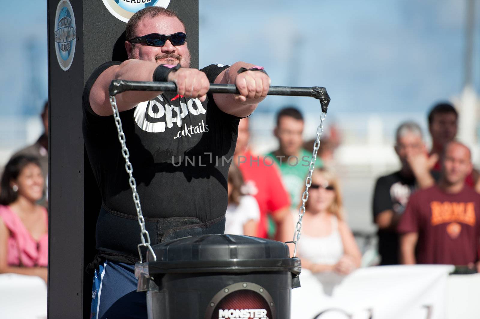 CANARY ISLANDS - SEPTEMBER 03: Warrick Brant from Australia lifting a heavy trash can for longest possible time during Strongman Champions League in Las Palmas September 03, 2011 in Canary Islands, Spain