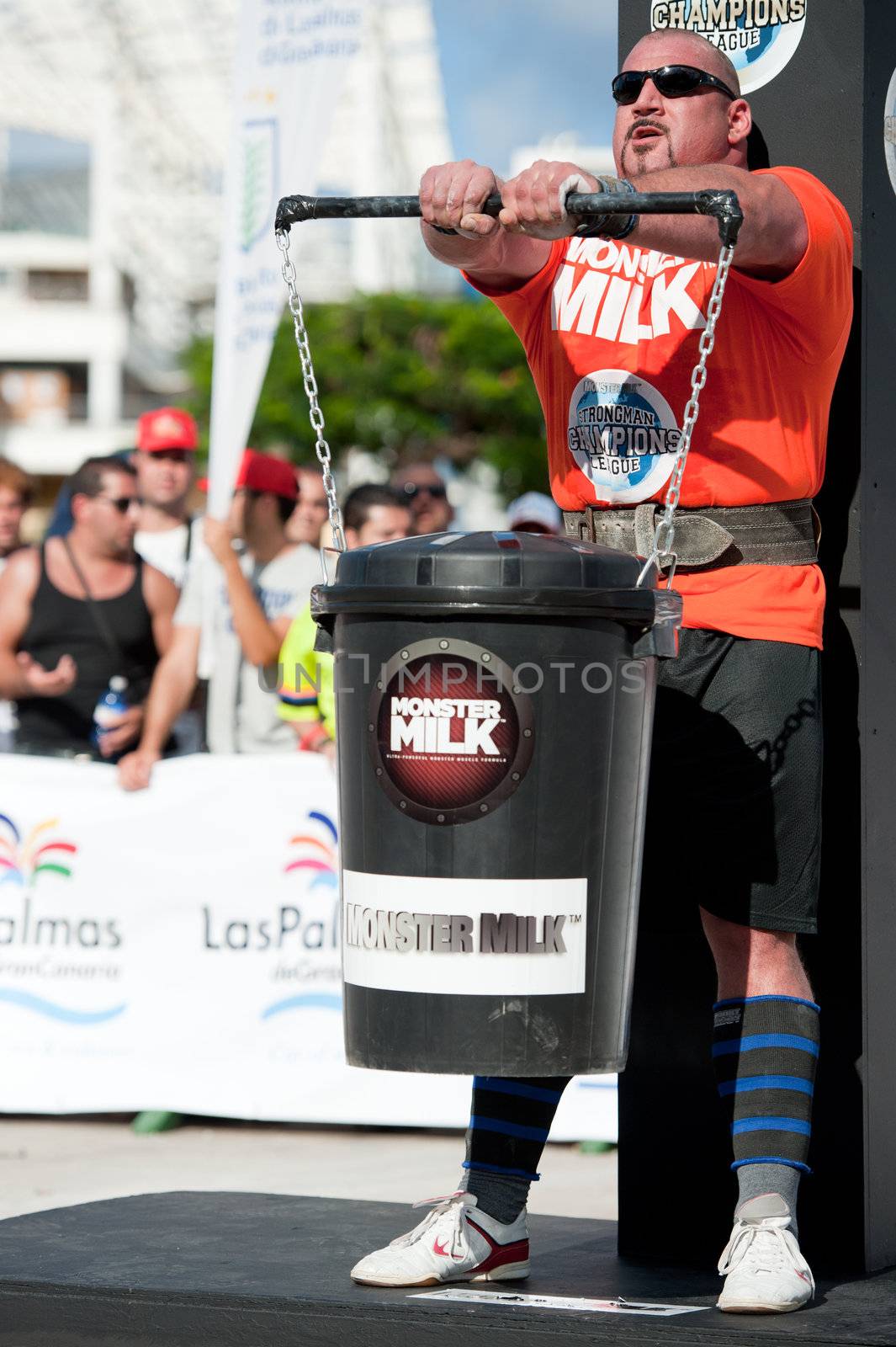 CANARY ISLANDS - SEPTEMBER 03: Ervin Katona from Serbia lifting a heavy trash can for longest possible time during Strongman Champions League in Las Palmas September 03, 2011 in Canary Islands, Spain