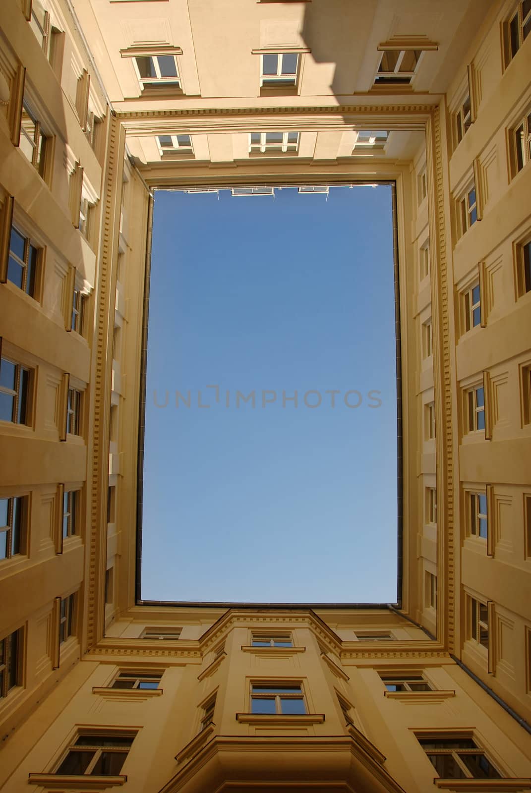 blue sky framed by yellow building in Budapest, Hungary