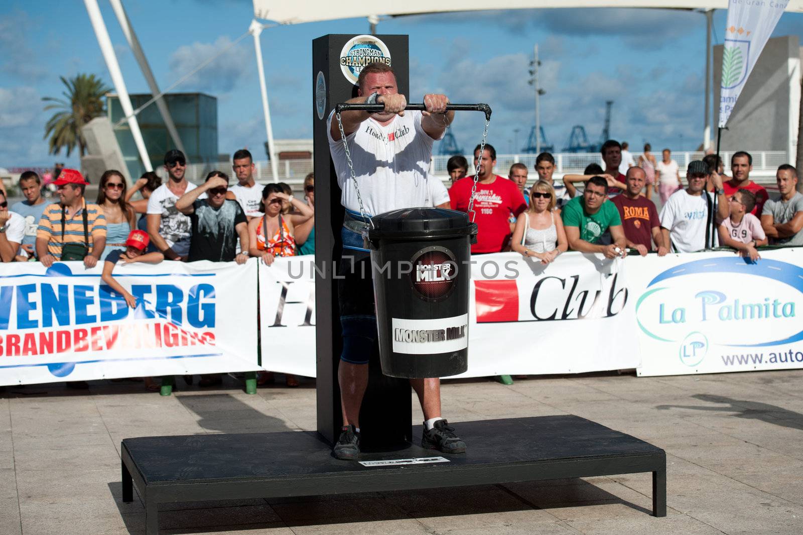 CANARY ISLANDS - SEPTEMBER 03: Lauri Nami from Estonia lifting a heavy trash can for longest possible time during Strongman Champions League in Las Palmas September 03, 2011 in Canary Islands, Spain