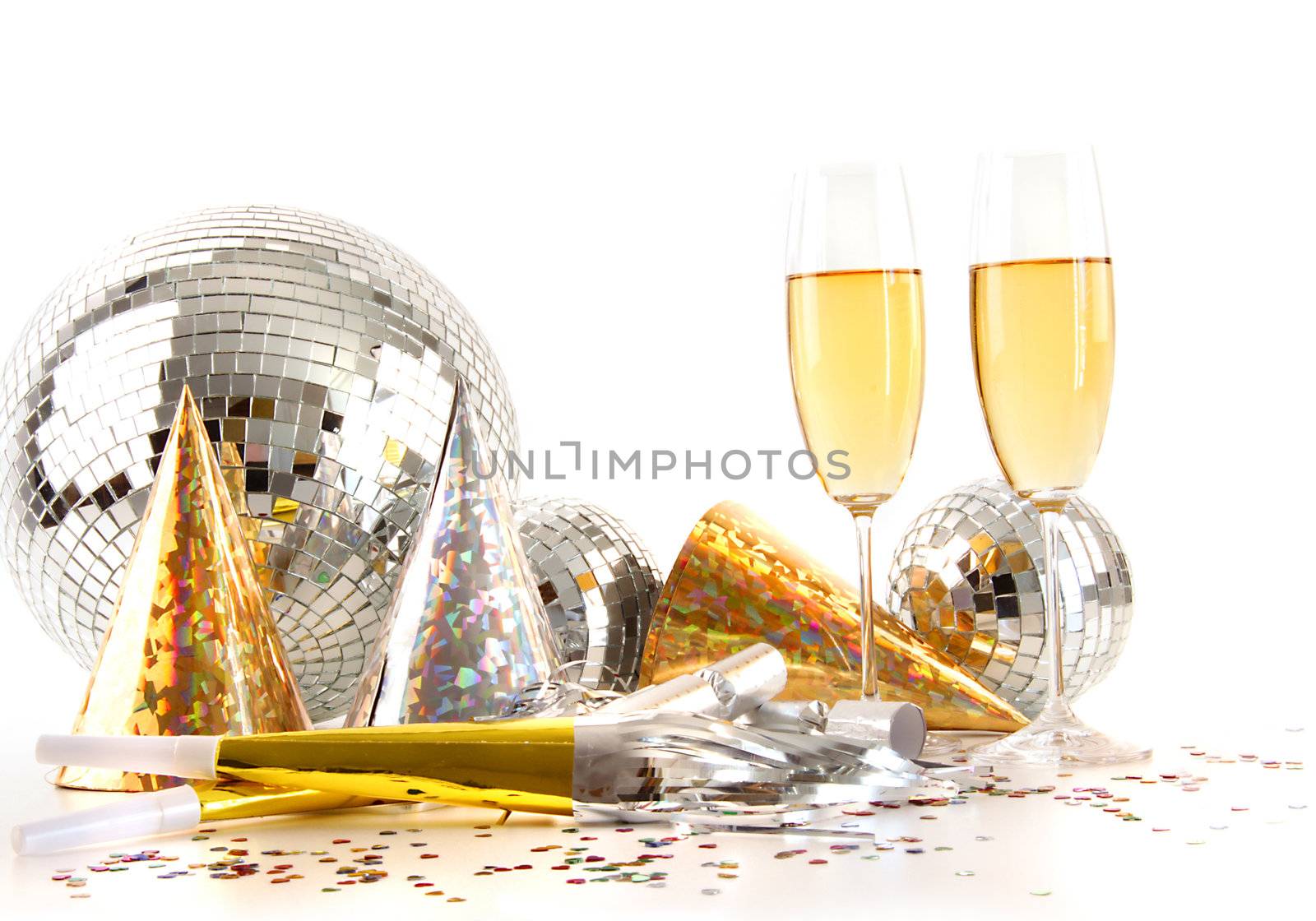 Champagne glasses with gold party hats and big disco ball