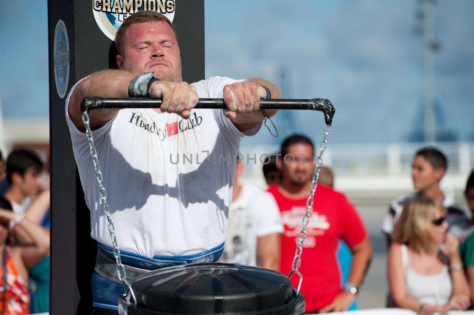 CANARY ISLANDS - SEPTEMBER 03: Lauri Nami from Estonia lifting a heavy trash can for longest possible time during Strongman Champions League in Las Palmas September 03, 2011 in Canary Islands, Spain