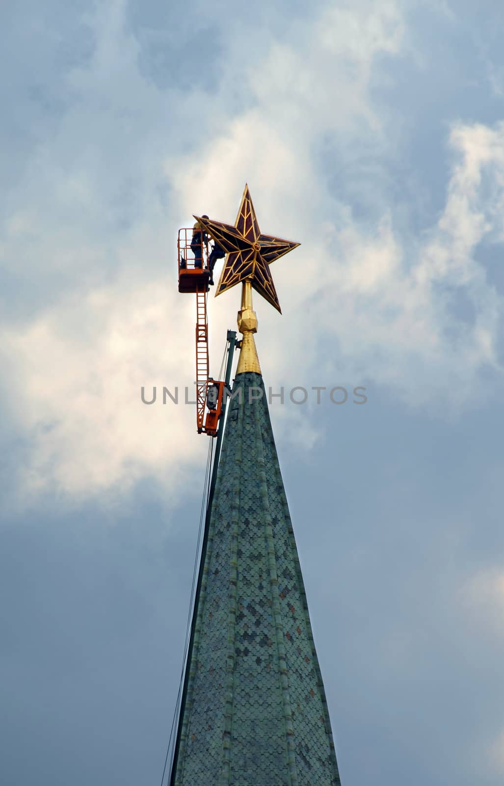 workers repairing the Kremlin tower star in Moscow, Russia