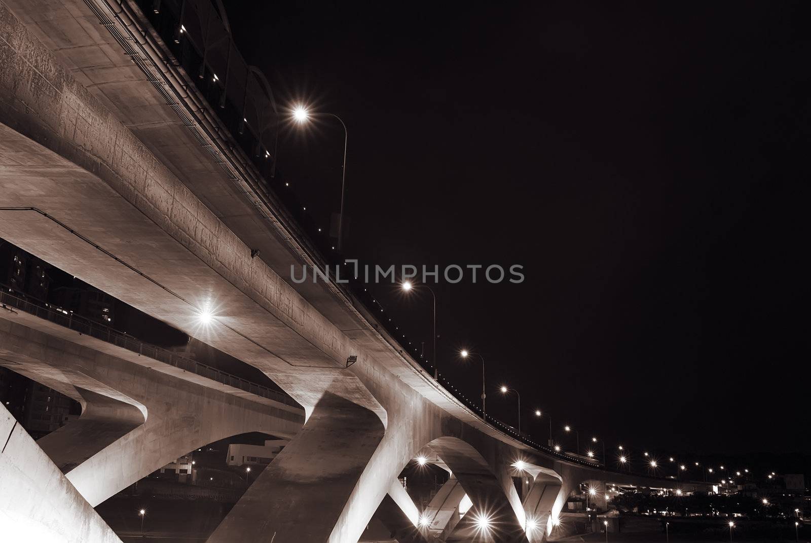 Cityscape of bridge with dark sky in the evening.