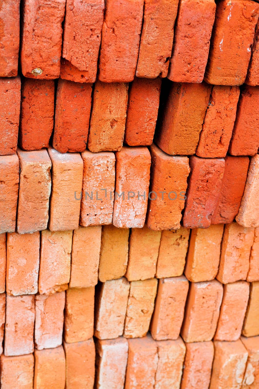 A beautifully stacked red and rust colored bricks.